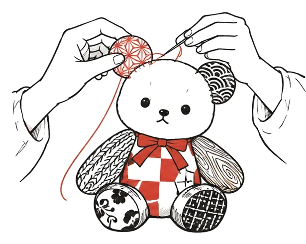 白いくみぐまに柄の布の耳を縫い付けている手元の絵